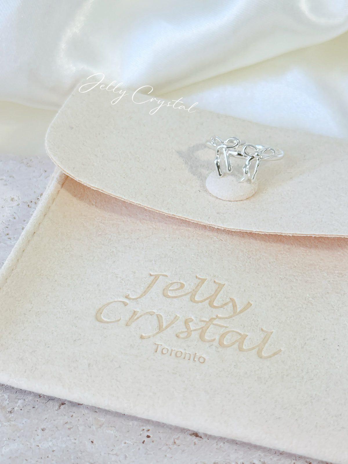 Sterling silver bow knot ring shown with its adjustable open band