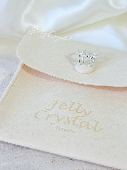 Sterling silver bow knot ring shown with its adjustable open band